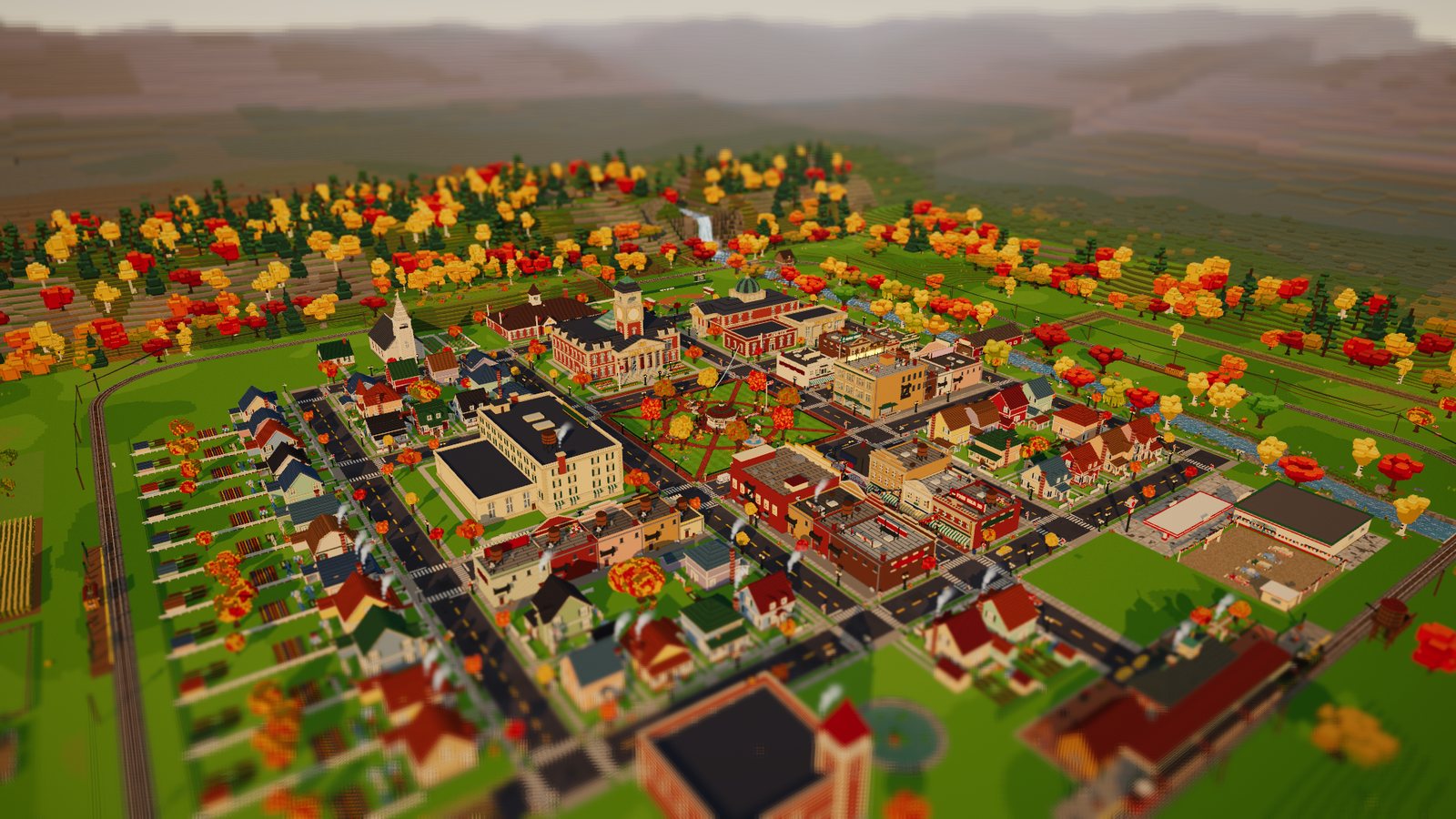 Acorn Falls from the air: a voxel town around a square, with a railway and autumn trees