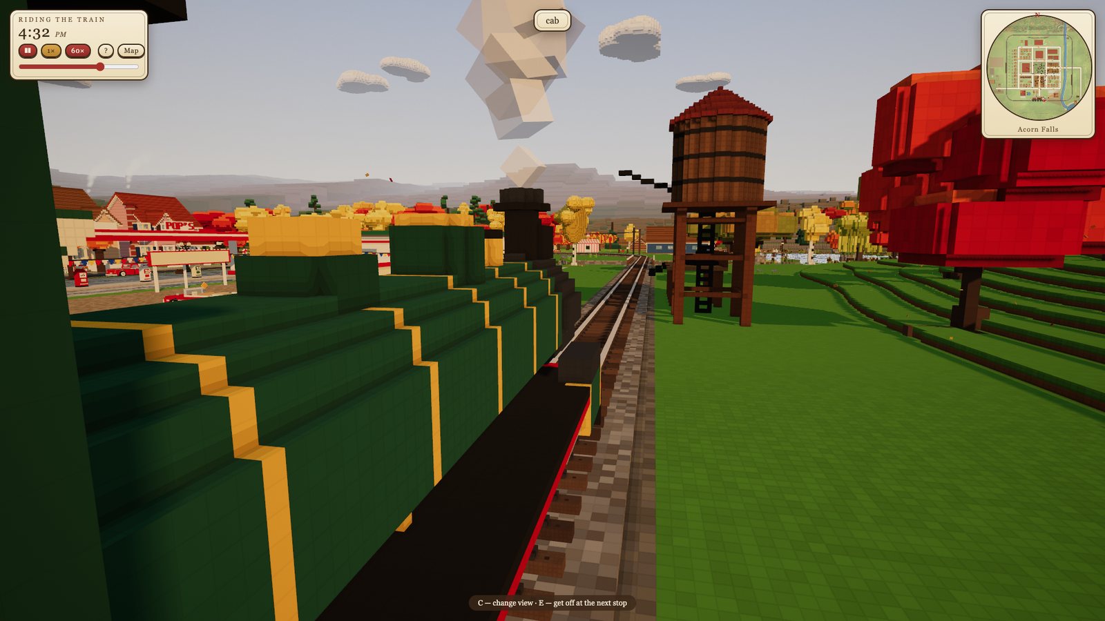 Riding in the cab of the green steam engine past a water tower