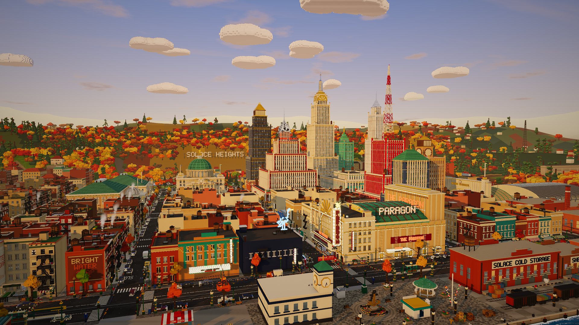 Port Solace from above at golden hour: the Paragon theatre, the harbour front and the art deco towers of downtown, with autumn hills behind