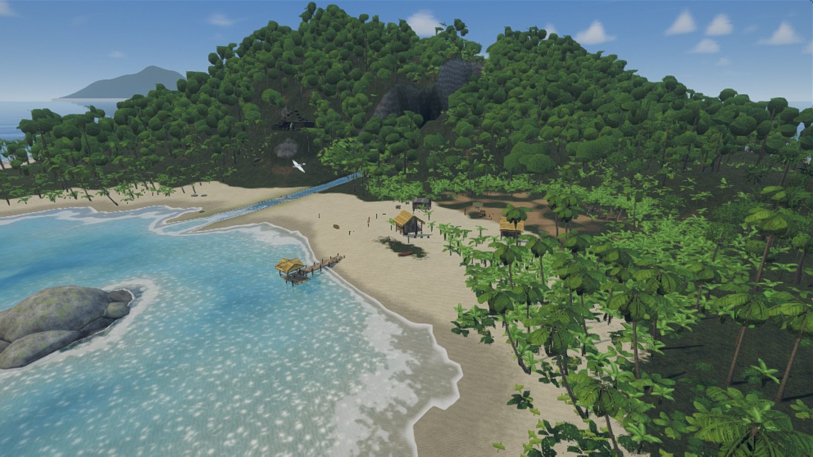 The beach of Landfall Cove from the air, with a boat pulled up on the sand