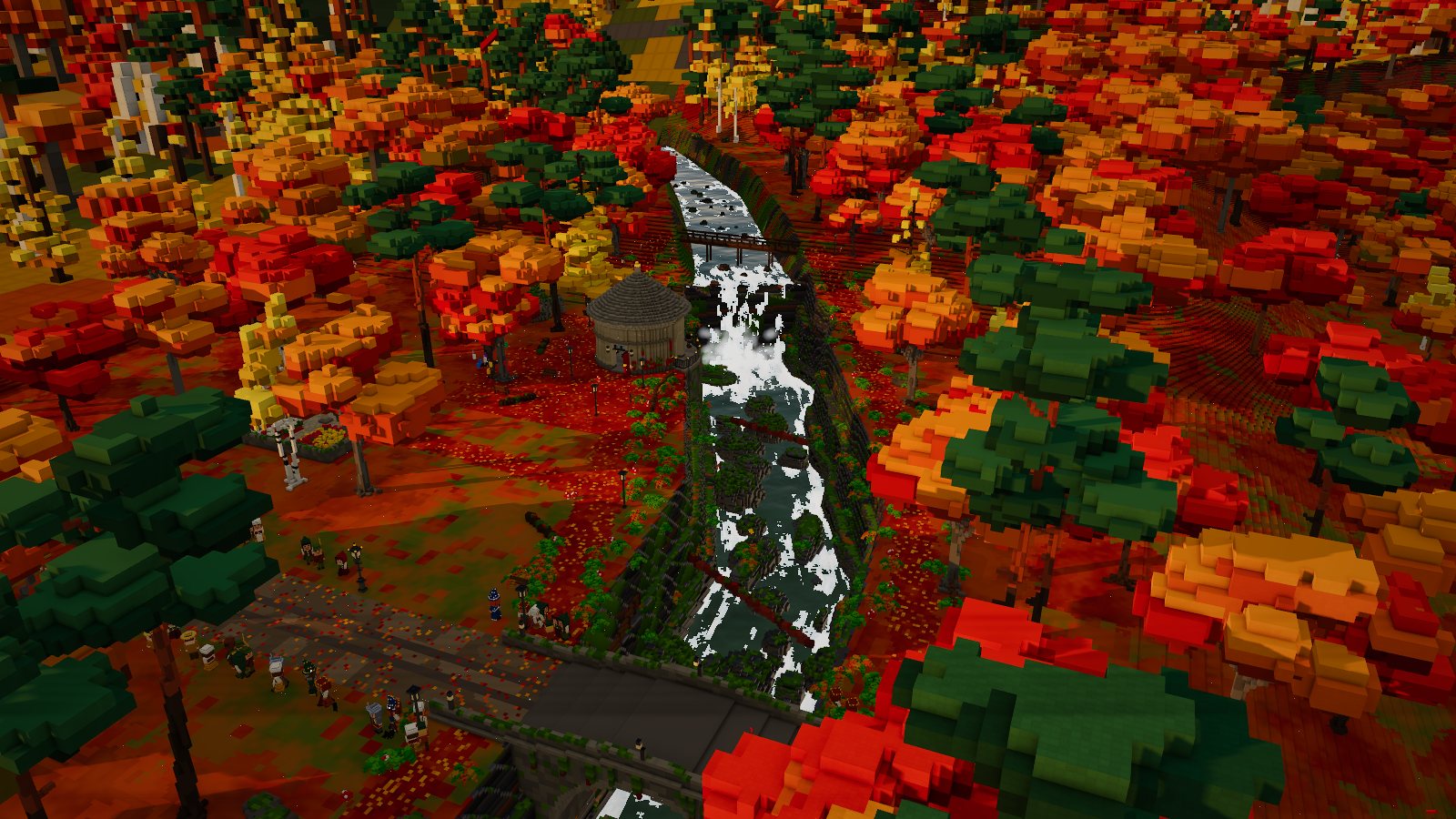 A river running through a wooded gorge of red and gold trees